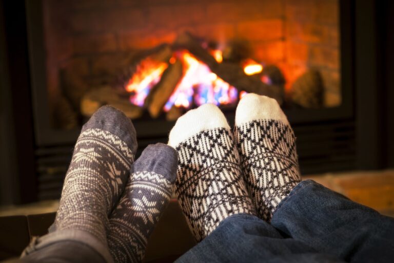 feet in socks warming by cozy fire