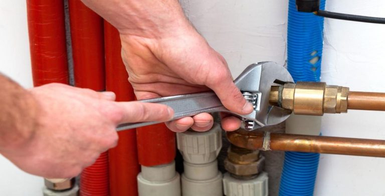 Technician Fixing Pipe With Wrench