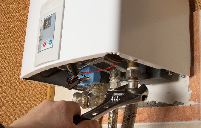 water heater repair with wrench